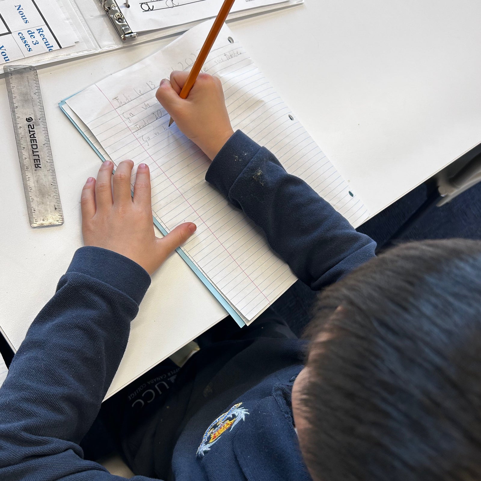 French Tutoring School Student Working on paper