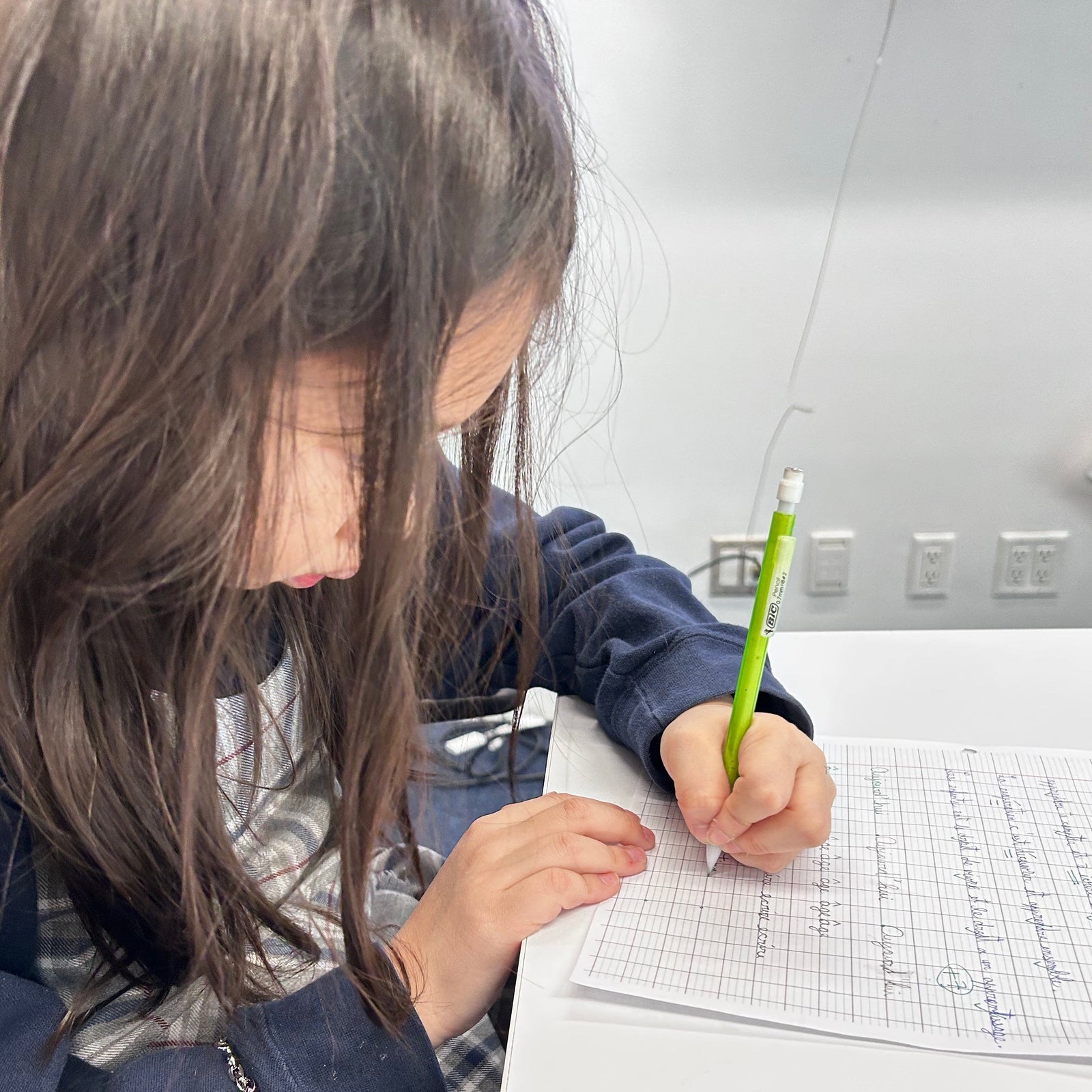 French Tutoring School Student Working on paper